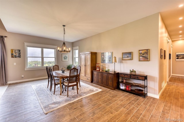 dining room featuring an inviting chandelier and light hardwood / wood-style flooring