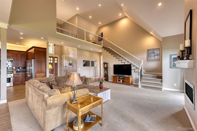 carpeted living room with a towering ceiling