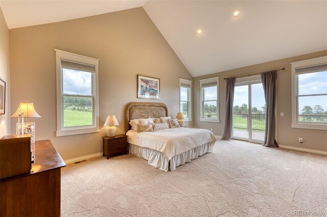 bedroom featuring light colored carpet, high vaulted ceiling, and access to outside