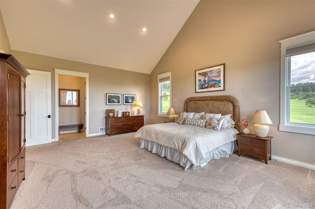 carpeted bedroom featuring high vaulted ceiling