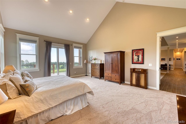 carpeted bedroom featuring access to exterior and high vaulted ceiling