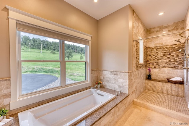 bathroom featuring tile patterned floors and independent shower and bath