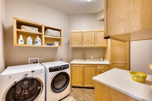 laundry room featuring cabinets, sink, and washing machine and dryer