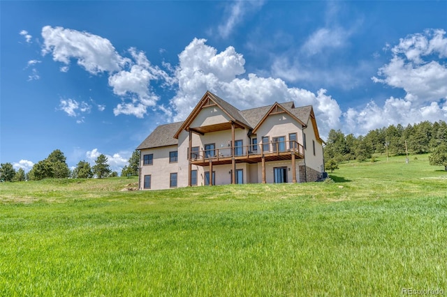 back of house with a deck and a lawn