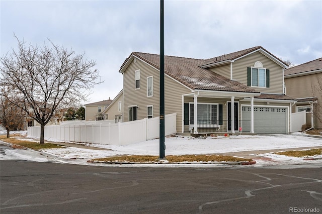 view of front property featuring covered porch and a garage