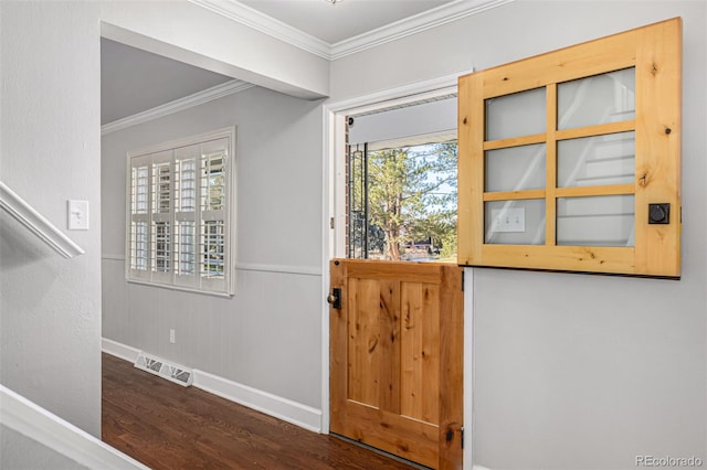 foyer entrance with ornamental molding and dark wood-type flooring