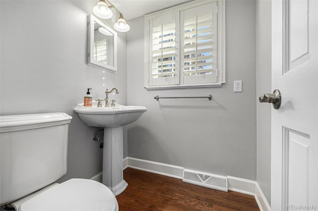 bathroom featuring hardwood / wood-style flooring and toilet