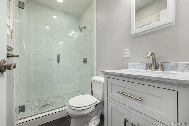 bathroom featuring vanity, toilet, a shower with shower door, and a baseboard heating unit