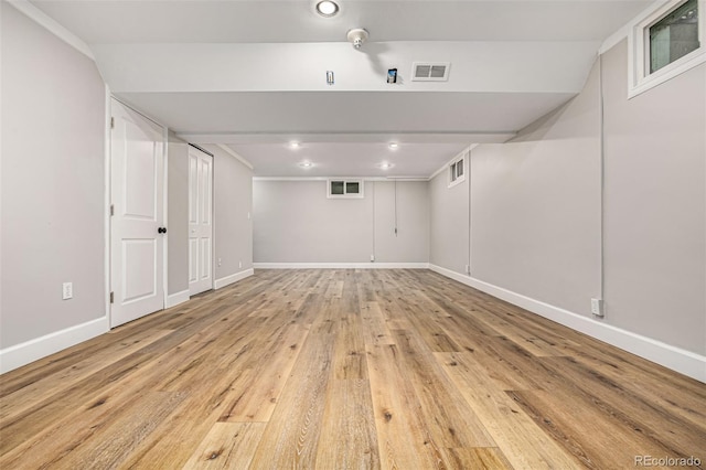 basement with light hardwood / wood-style flooring