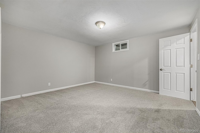 carpeted spare room featuring a textured ceiling