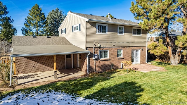 rear view of house with a yard and a patio area