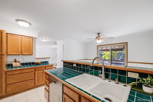 3870 S Ouray Way, Aurora, CO 80013 - kitchen with tile countertops, dishwashing machine, ornamental molding, a ceiling fan, and light tile patterned floors