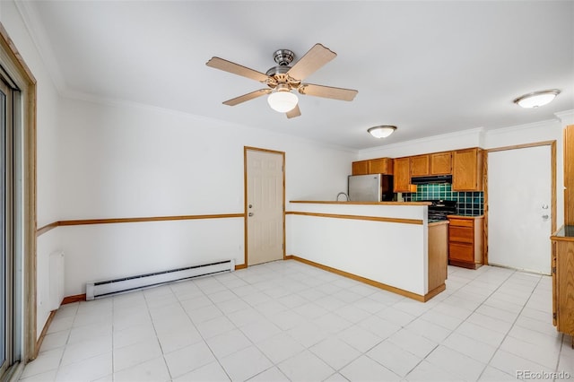 3870 S Ouray Way, Aurora, CO 80013 - kitchen with freestanding refrigerator, a baseboard radiator, a peninsula, under cabinet range hood, and ceiling fan