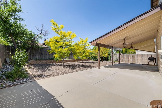 3870 S Ouray Way, Aurora, CO 80013 - fenced backyard with ceiling fan and a patio area