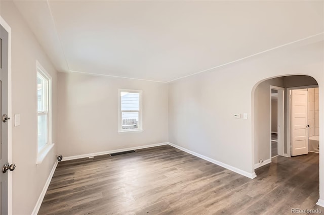 spare room with dark hardwood / wood-style flooring