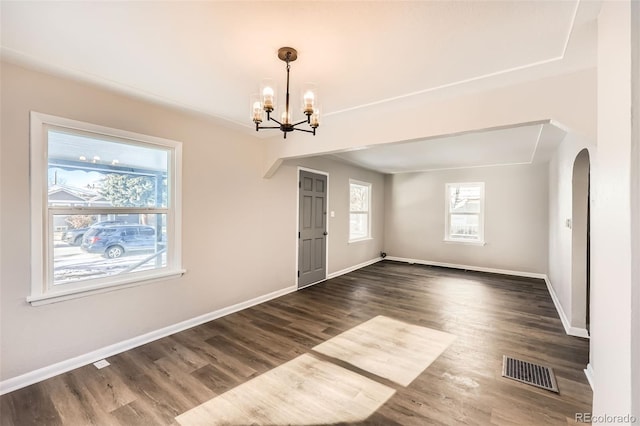 interior space featuring dark hardwood / wood-style floors and an inviting chandelier