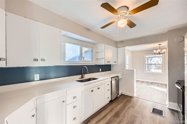 kitchen featuring stainless steel dishwasher, a healthy amount of sunlight, white cabinetry, and sink