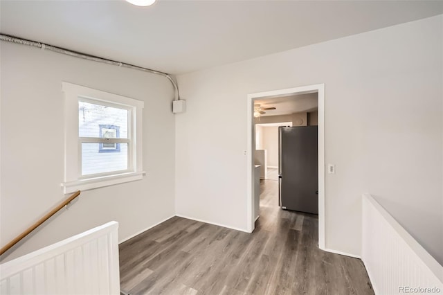 interior space featuring radiator, ceiling fan, and wood-type flooring