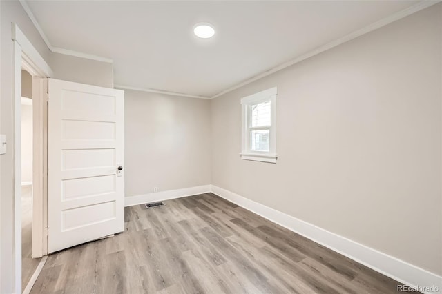 unfurnished room featuring light hardwood / wood-style flooring and ornamental molding