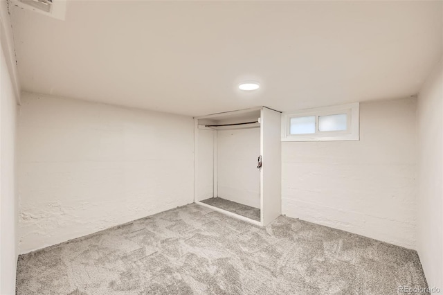 basement featuring light colored carpet