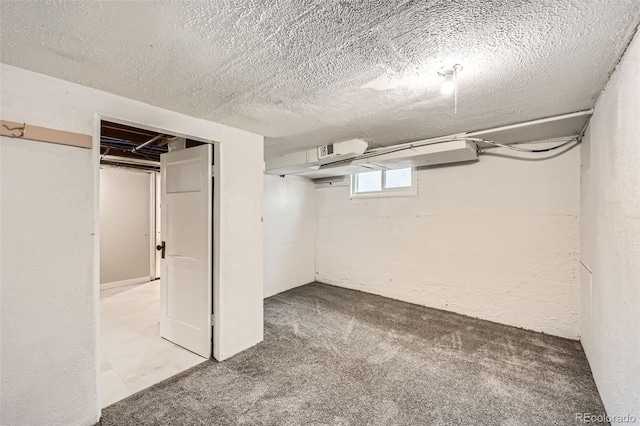 basement featuring carpet floors and a textured ceiling