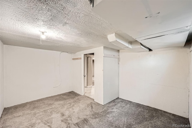 basement with carpet and a textured ceiling