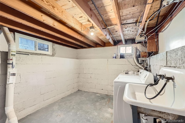 basement featuring washing machine and clothes dryer and sink