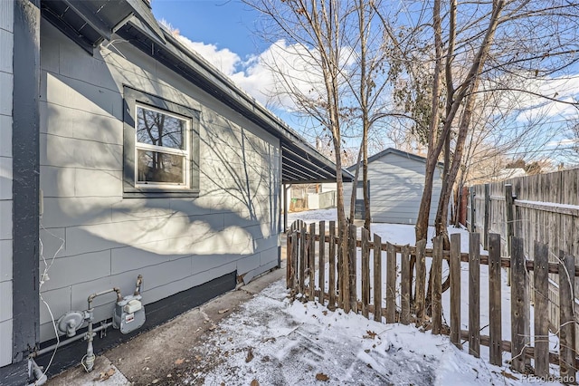 view of snowy exterior with an outbuilding