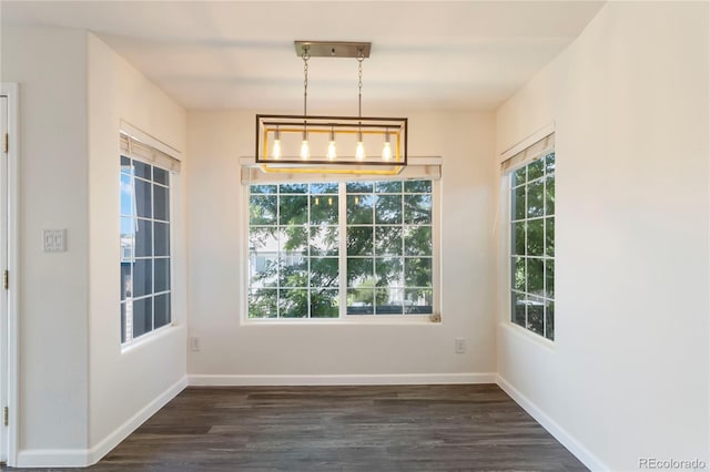 3825 Canyon Ranch Rd Unit 203, Highlands Ranch, CO 80126 - unfurnished dining area featuring dark wood-style flooring and baseboards