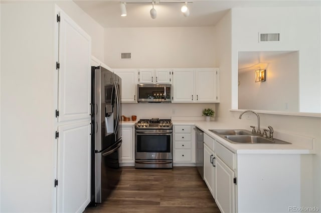 3825 Canyon Ranch Rd Unit 203, Highlands Ranch, CO 80126 - kitchen featuring stainless steel appliances, white cabinets, light countertops, dark wood-type flooring, and track lighting