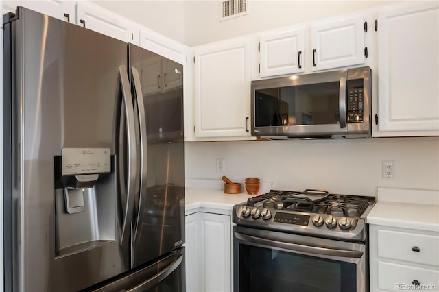 3825 Canyon Ranch Rd Unit 203, Highlands Ranch, CO 80126 - kitchen featuring appliances with stainless steel finishes, light countertops, and white cabinetry