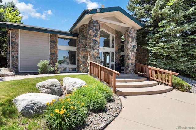 3825 Canyon Ranch Rd Unit 203, Highlands Ranch, CO 80126 - view of front facade featuring stone siding and covered porch