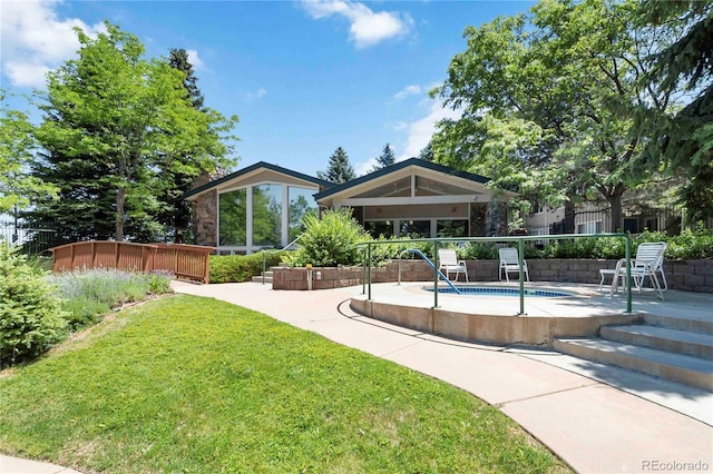 3825 Canyon Ranch Rd Unit 203, Highlands Ranch, CO 80126 - rear view of property with a patio area and a yard