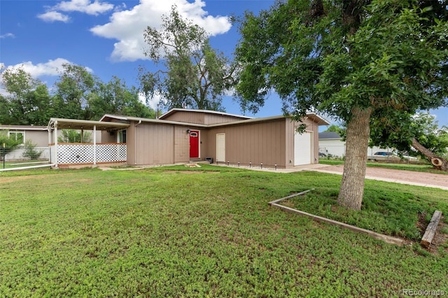 1209 Maxwell St, Colorado Springs, CO 80906 - view of front facade with a front yard, concrete driveway, and a garage