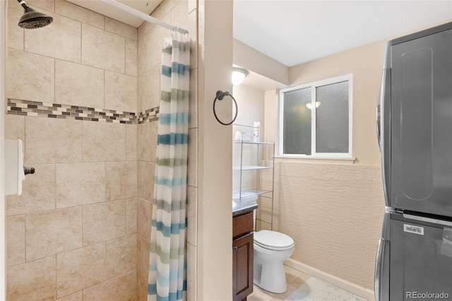 1209 Maxwell St, Colorado Springs, CO 80906 - full bathroom featuring stacked washer / dryer, a tile shower, vanity, and tile patterned flooring
