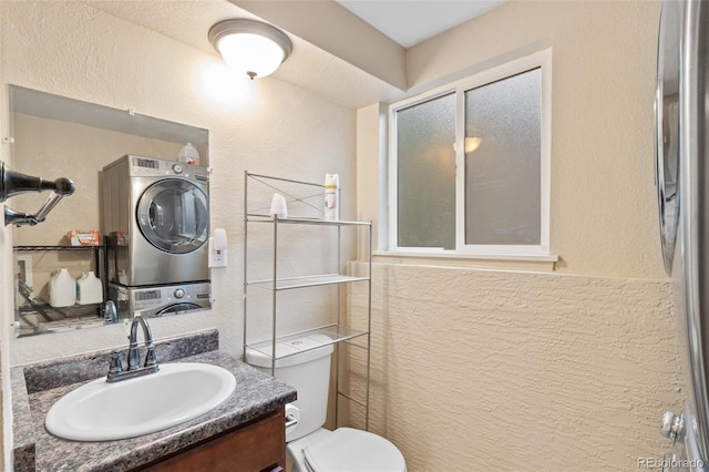 1209 Maxwell St, Colorado Springs, CO 80906 - bathroom with stacked washer / drying machine, vanity, an enclosed shower, and a textured wall
