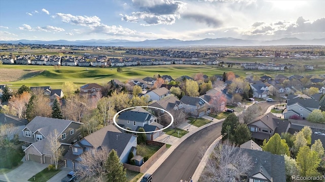 drone / aerial view featuring a residential view, a mountain view, and golf course view