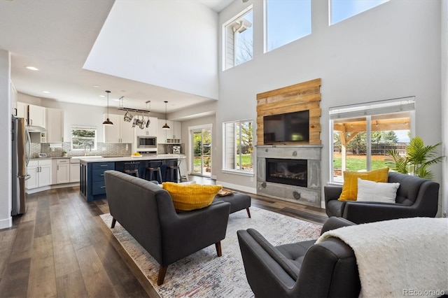 4815 Lucille Ct, Loveland, CO 80537 - living room with dark wood-style floors, a premium fireplace, recessed lighting, and a high ceiling