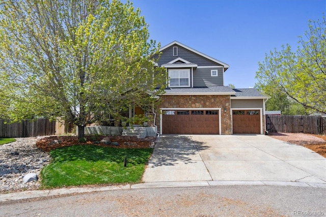 4815 Lucille Ct, Loveland, CO 80537 - view of front of house with driveway, stone siding, and a garage