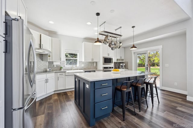 4815 Lucille Ct, Loveland, CO 80537 - kitchen featuring appliances with stainless steel finishes, plenty of natural light, white cabinets, and recessed lighting