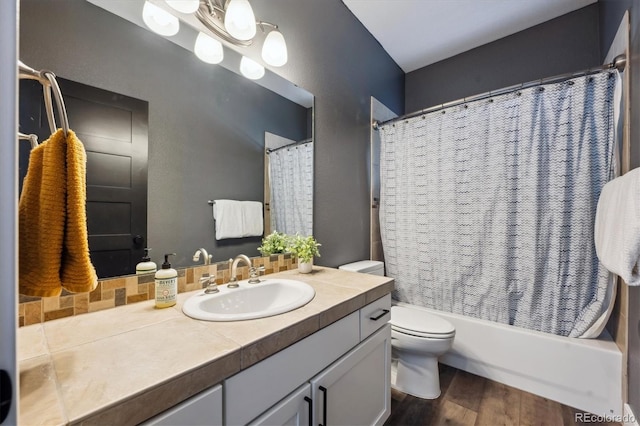4815 Lucille Ct, Loveland, CO 80537 - full bath featuring vanity, toilet, wood finished floors, and shower / bathtub combination with curtain