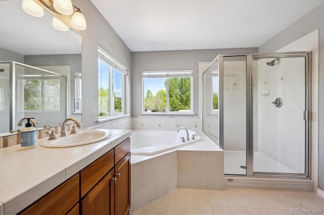 4815 Lucille Ct, Loveland, CO 80537 - bathroom featuring vanity, a garden tub, a shower stall, and tile patterned flooring