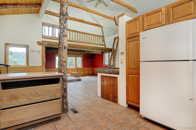16715 Shadow Ln, Nathrop, CO 81236 - kitchen with freestanding refrigerator, high vaulted ceiling, a wainscoted wall, wooden walls, and ceiling fan