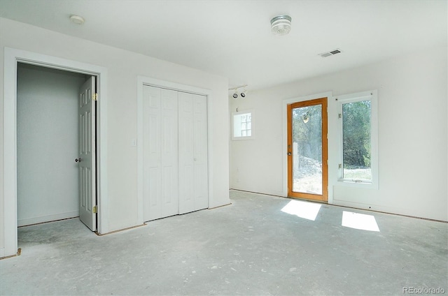 16715 Shadow Ln, Nathrop, CO 81236 - unfurnished bedroom featuring unfinished concrete flooring, a closet, and access to exterior