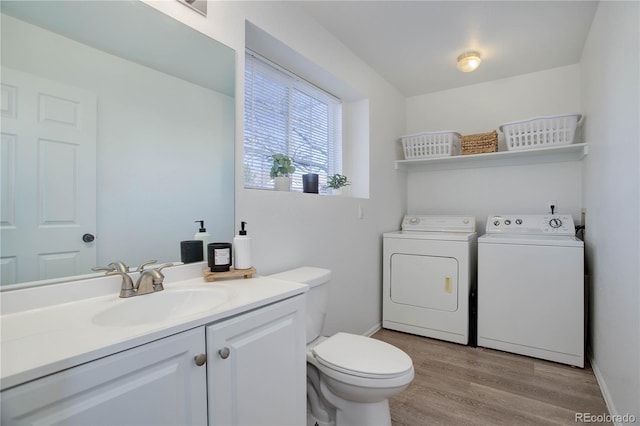 bathroom featuring separate washer and dryer, vanity, hardwood / wood-style floors, and toilet