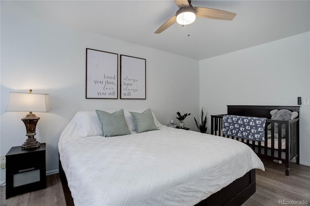 bedroom with hardwood / wood-style floors and ceiling fan