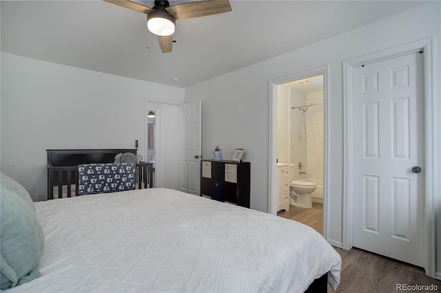 bedroom featuring connected bathroom, hardwood / wood-style flooring, and ceiling fan