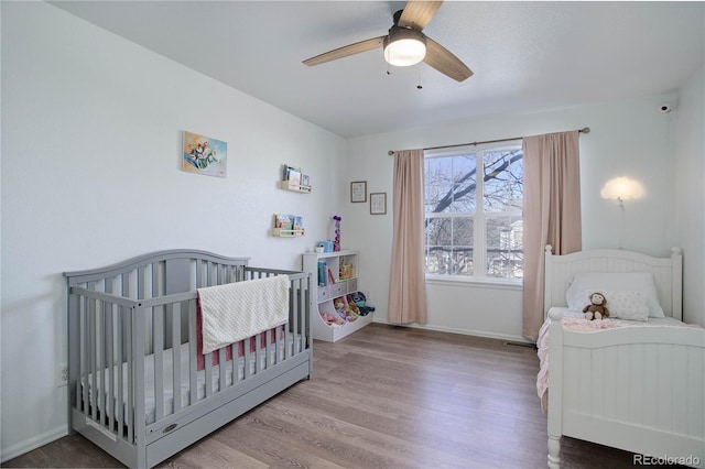 bedroom featuring hardwood / wood-style flooring and ceiling fan