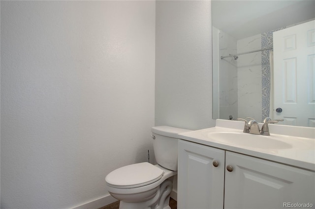 bathroom with walk in shower, vanity, and toilet