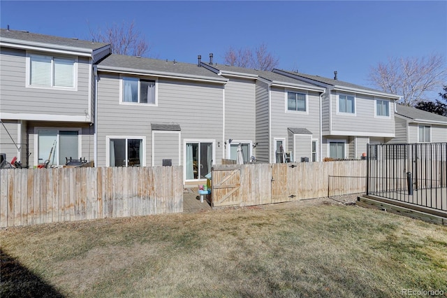 back of house featuring a yard